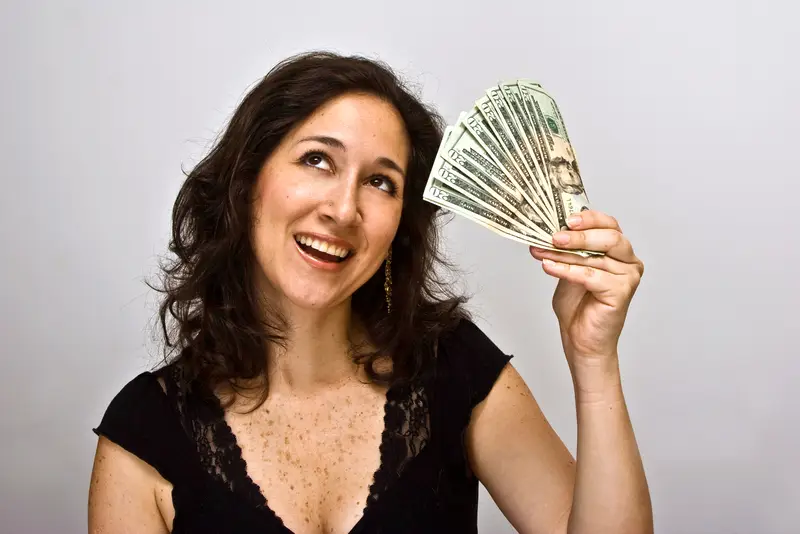 woman with cash in hand is very happy