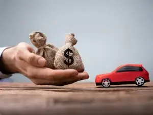 toy car and bags of money represent an auto title loan