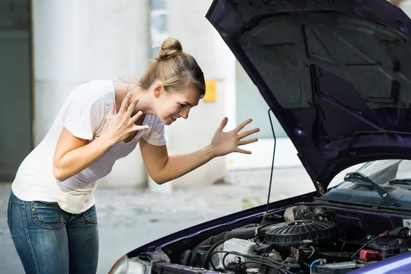 woman not at all happy about her broken down car