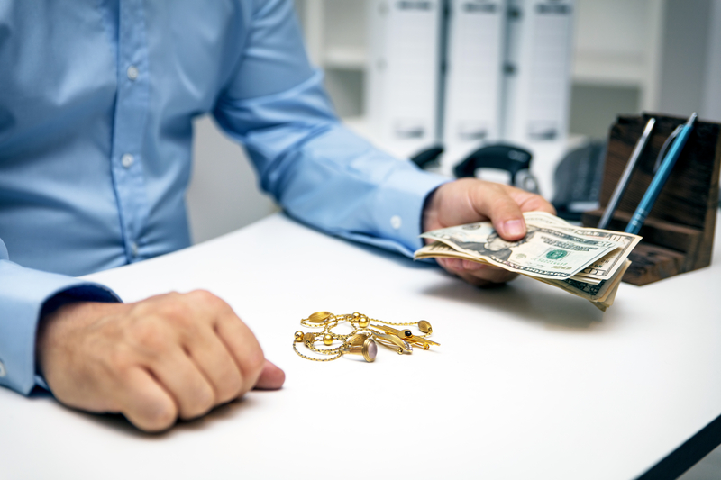 man getting cash for old jewelry